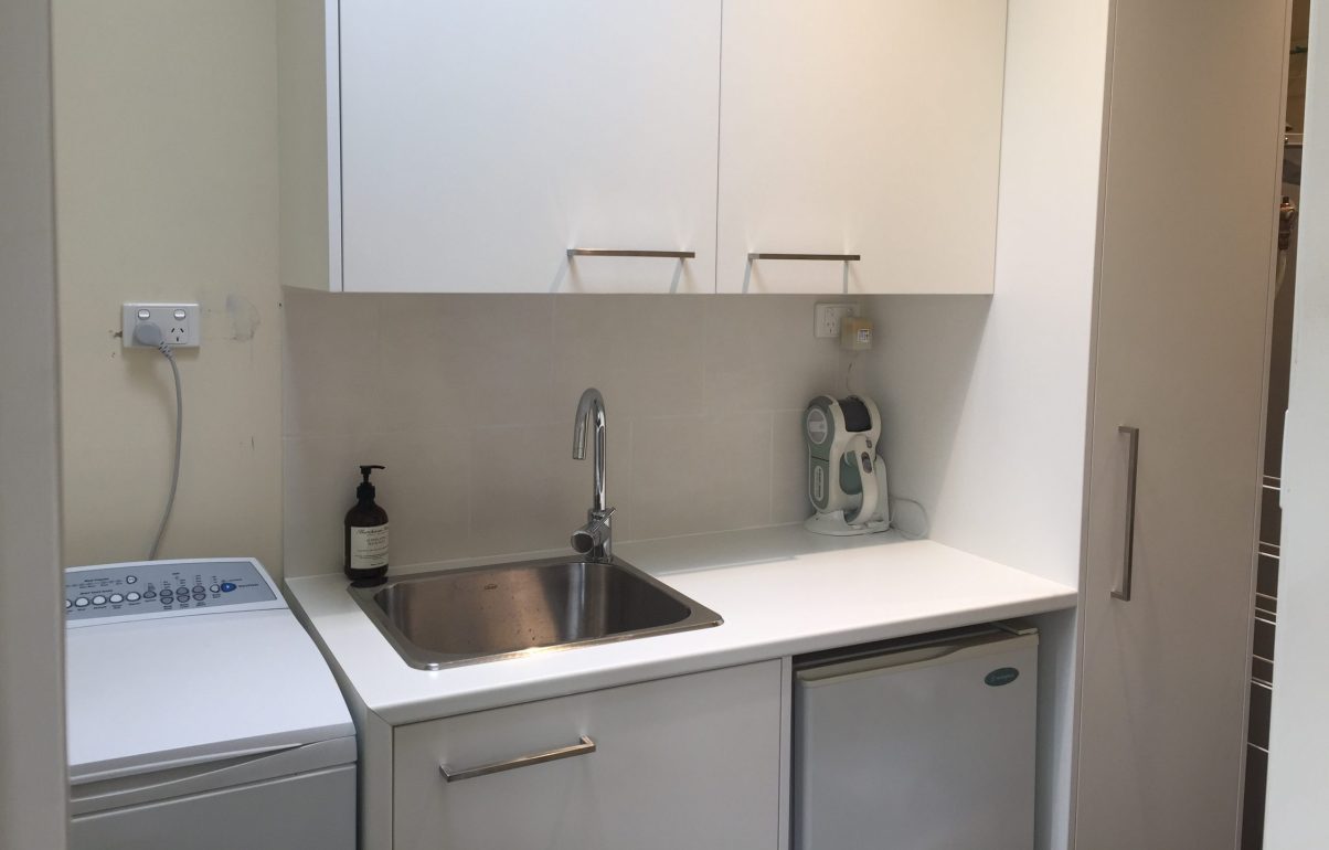 New laundry sink and cabinets as part of a finished laundry renovation in Melbourne. 